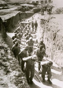 Forced laborers hauling cartloads of earth for the construction of the “Russian camp” at the Mauthausen concentration camp in Austria, April-May 1942. Photo credit: USHMM #12352