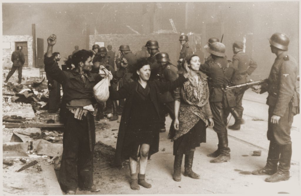 SS troops guard members of the Jewish resistance captured during the liquidation of the Warsaw ghetto, April 1943. Photo credit: USHMM #46193