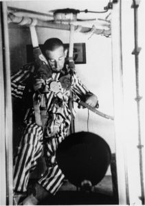 A Dachau concentration camp prisoner in a special chamber loses consciousness in response to changing air pressure during high-altitude experiments, March-August 1942. Photo credit: USHMM #78619A