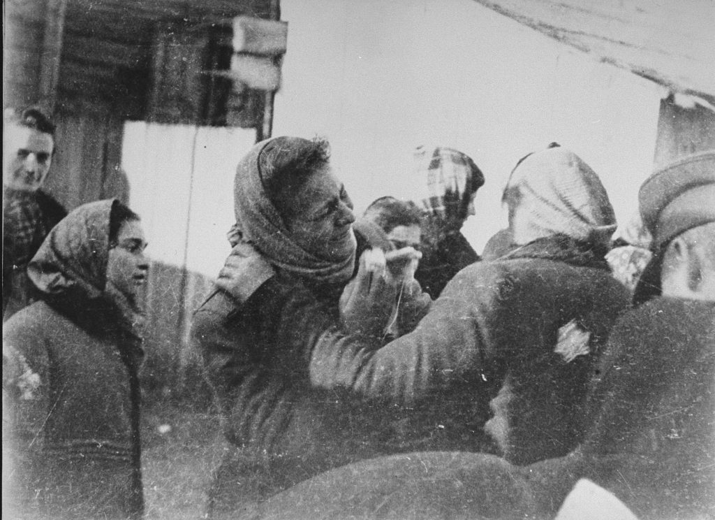 Two women bid each other farewell at an assembly point in the Kovno (Kaunas) ghetto during a deportation action to Estonia. Kaunas, Lithuania, October 26, 1942. Photo credit: USHMM #81088