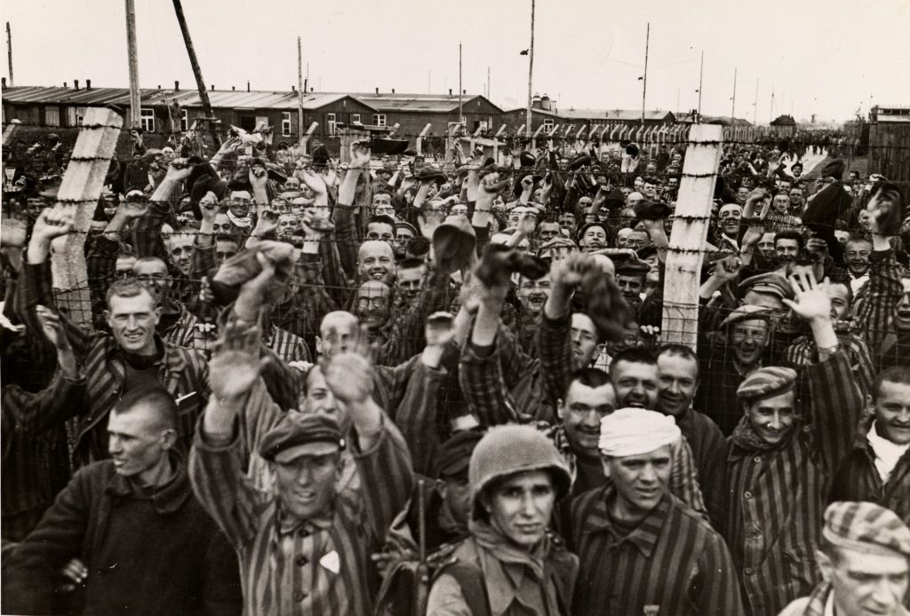 Prisoners from the Allach concentration camp, the largest subcamp of Dachau, celebrate their liberation by American soldiers, April 30, 1945. Photo credit: USHMM #49653