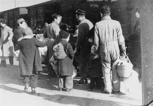 Members of the Ordedienst (Jewish police) supervise the deportation of Jews from the Westerbork transit camp. Photo credit: USHMM #01343