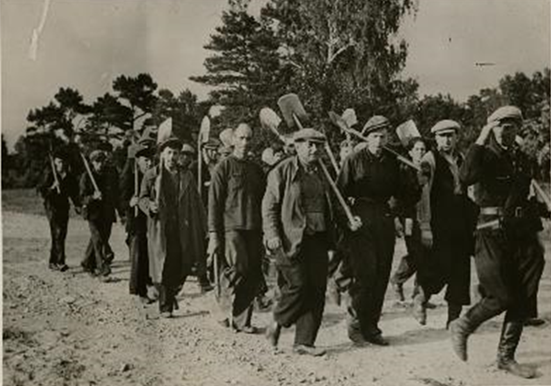 A group of Jewish prisoners marching towards forced labor in Liepāja, Latvia, August 1941. Photo credit: USHMM #55155