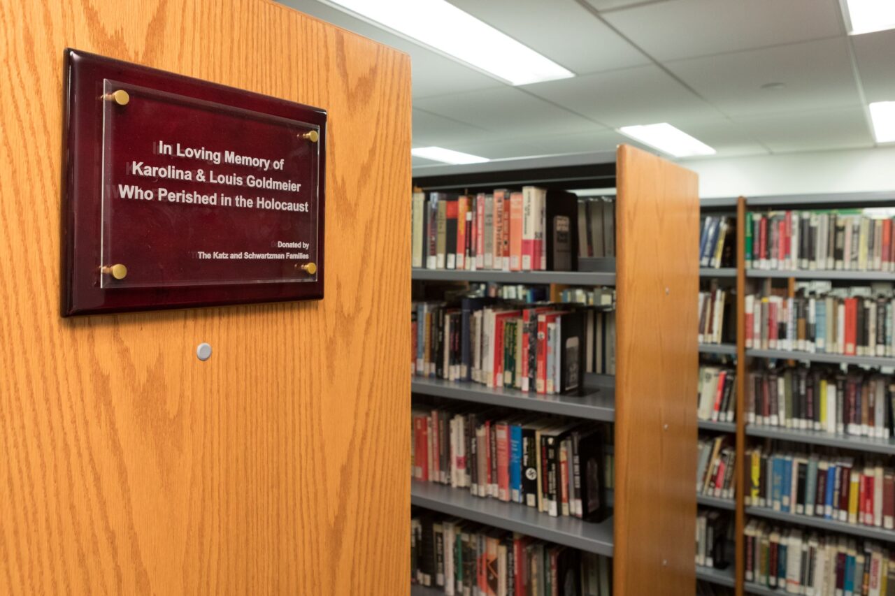 Image of specialized library stacks with a memorial plaque inside the KHC