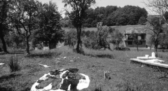 Image of from Vlasenica, 2002. Copyright Paul Lowe VII Photo. Clothes from a victim of ethnic cleansing are laid out in the sun to dry before being examined for clues as to the identity of the victim.
