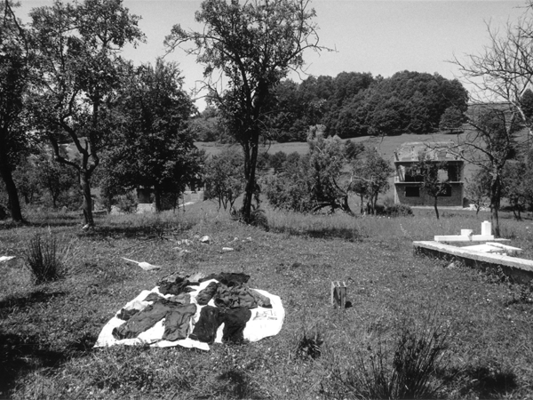 Image of from Vlasenica, 2002. Copyright Paul Lowe VII Photo. Clothes from a victim of ethnic cleansing are laid out in the sun to dry before being examined for clues as to the identity of the victim.