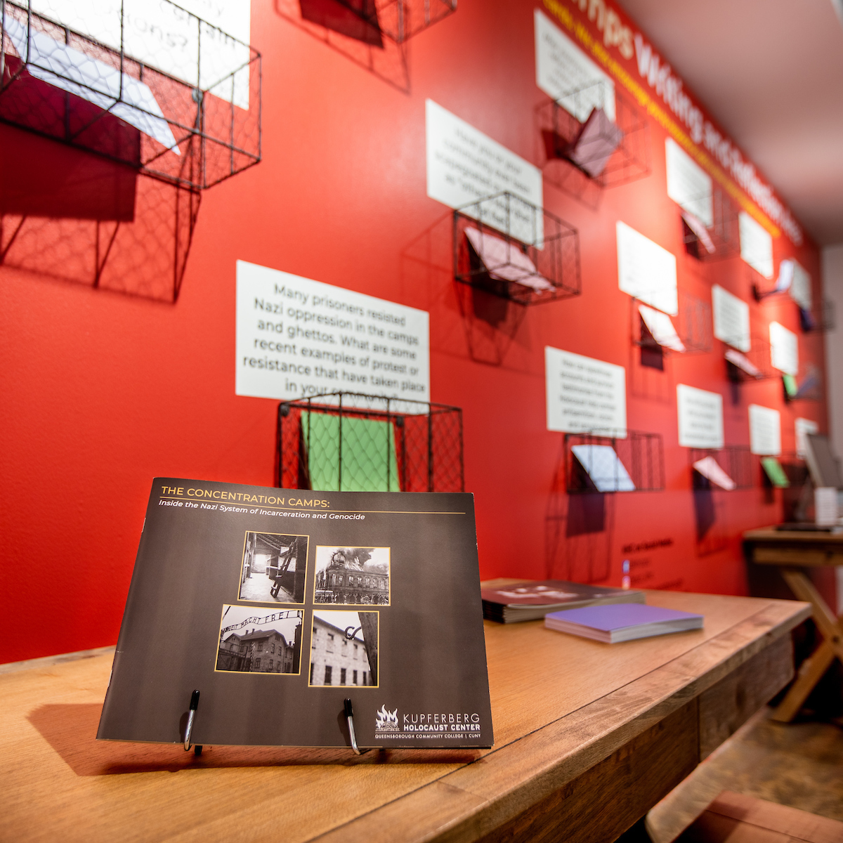 Interior image of the KHC featuring the front cover of the exhibition title in front of the student reflection wall